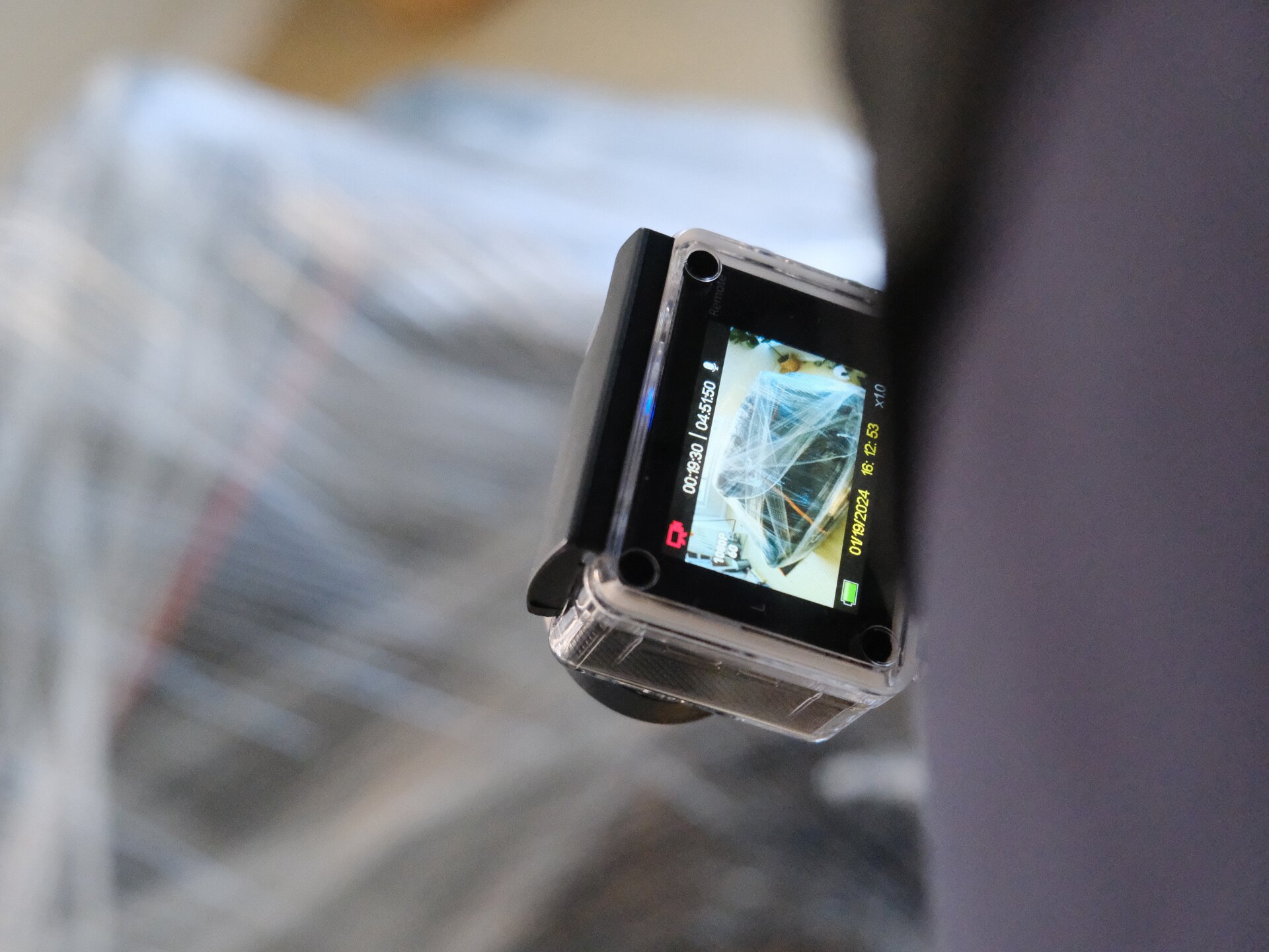 Body camera recording a move — timestamp visible on LCD screen